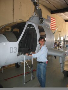 Norman standing in front of helicopter